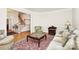 Comfortable living room featuring hardwood floors, a rug, and views of the foyer and staircase at 9800 Deer Brook Ln, Charlotte, NC 28210