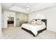 Main bedroom with tray ceiling, glass block wall and access to the main bathroom at 9800 Deer Brook Ln, Charlotte, NC 28210