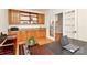 Inviting home office with custom wood cabinets, granite countertops, and bright french doors at 9800 Deer Brook Ln, Charlotte, NC 28210