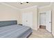 A bright bedroom features an entrance door, carpet floors and closet at 982 Old Trace Nw Rd, Concord, NC 28027