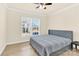 Bright bedroom with hardwood floors, a ceiling fan, a window view, and a comfortable bed at 982 Old Trace Nw Rd, Concord, NC 28027