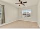 Bedroom featuring neutral carpet, a ceiling fan, and natural light from a window at 982 Old Trace Nw Rd, Concord, NC 28027