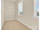 Spare bedroom with neutral carpet and a view from the double windows at 982 Old Trace Nw Rd, Concord, NC 28027