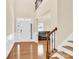 Welcoming entryway with hardwood floors, staircase, and view into the living room at 982 Old Trace Nw Rd, Concord, NC 28027