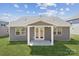 Backyard view of house featuring gray siding and covered patio at 9932 Manor Vista Trl, Kannapolis, NC 28027