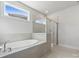 Bright bathroom with soaking tub, walk-in shower, and modern finishes at 9932 Manor Vista Trl, Kannapolis, NC 28027