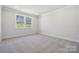 Bright bedroom with large window, plush carpet, and plenty of natural light at 9932 Manor Vista Trl, Kannapolis, NC 28027