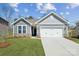 Charming home featuring a two-car garage, stone accents, manicured lawn, and beautiful curb appeal at 9932 Manor Vista Trl, Kannapolis, NC 28027