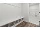 Mud room with built-in bench, coat hooks and wood-look floors at 9932 Manor Vista Trl, Kannapolis, NC 28027