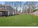 Expansive backyard with lush green grass, bordered by mature trees, perfect for outdoor entertaining and relaxation at 1036 Bramcote Ln, Charlotte, NC 28215