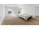 Neutral bedroom features carpeted floors, large windows, and neutral walls at 1036 Bramcote Ln, Charlotte, NC 28215