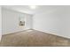 Neutral bedroom features carpeted floors, large windows, and neutral walls at 1036 Bramcote Ln, Charlotte, NC 28215