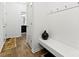 Hallway with bench and coat hooks provides practical storage in an organized mudroom at 1036 Bramcote Ln, Charlotte, NC 28215