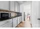 Modern kitchen features sleek countertops and stainless steel microwave with tile backsplash at 1036 Bramcote Ln, Charlotte, NC 28215