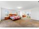 Bright main bedroom features neutral walls, carpeted floors, and generous natural light at 1036 Bramcote Ln, Charlotte, NC 28215