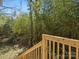 Backyard staircase with wooden handrail surrounded by lush landscaping and greenery at 105 S York St, Lancaster, SC 29720