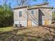 Exterior of home with basement access, AC units, windows and foliage at 105 S York St, Lancaster, SC 29720