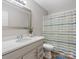 Clean bathroom featuring a modern vanity, sink, and a shower with a colorful striped curtain at 105 S York St, Lancaster, SC 29720