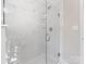 Bathroom featuring a large glass shower with marble tiling and shelving for toiletries at 105 S York St, Lancaster, SC 29720