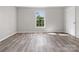 Neutral bedroom with wood floors, bright natural light, and a window with an outside view at 105 S York St, Lancaster, SC 29720