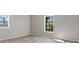 Neutral bedroom with wood floors, two windows with outside views, and bright natural light at 105 S York St, Lancaster, SC 29720