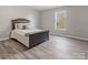 Neutral bedroom with a queen bed, wood floors, and a window with a view at 105 S York St, Lancaster, SC 29720