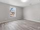 Bright bedroom featuring hardwood floors, a window with outside view and neutral paint at 105 S York St, Lancaster, SC 29720
