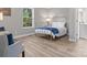 Bedroom featuring hardwood floors, a bed, and a seating area at 105 S York St, Lancaster, SC 29720