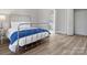 This bedroom has a metal bed frame, wood floors, and an ensuite bathroom with a glass shower at 105 S York St, Lancaster, SC 29720