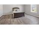 Neutral bedroom with a queen bed, wood floors, and a window with a view at 105 S York St, Lancaster, SC 29720