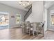 Bright dining area adjacent to the staircase features a table for four and complements the home's modern design at 105 S York St, Lancaster, SC 29720