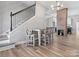 Bright dining area adjacent to the staircase features a table for four and complements the home's modern design at 105 S York St, Lancaster, SC 29720
