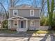 Charming two-story home with gray siding, a covered front porch, and a well-maintained lawn at 105 S York St, Lancaster, SC 29720