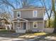 Charming two-story home with gray siding, a covered front porch, and a well-maintained lawn at 105 S York St, Lancaster, SC 29720