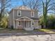 Charming two-story home with gray siding, a covered front porch, and a well-maintained lawn at 105 S York St, Lancaster, SC 29720