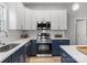 Bright kitchen showcasing white cabinets, stainless steel appliances, countertops, and an undermount sink at 105 S York St, Lancaster, SC 29720