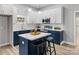 Modern kitchen boasts white cabinets, navy blue island and countertops, stainless steel appliances and ample natural light at 105 S York St, Lancaster, SC 29720