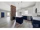 Modern open kitchen boasts an island and a unique brick column design feature, blending contemporary with rustic elements at 105 S York St, Lancaster, SC 29720