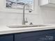 Close-up of a modern kitchen sink with a stainless steel faucet, quartz countertops, and subway tile backsplash at 105 S York St, Lancaster, SC 29720