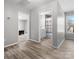 Bright, neutral living space with wood floors and multiple doorways to bathroom and bedroom at 105 S York St, Lancaster, SC 29720