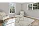 Cozy sitting area showcasing hardwood floors, windows, and two chairs at 105 S York St, Lancaster, SC 29720