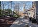 Spacious backyard showcasing a patio with outdoor seating, dining area, lush landscaping, and mature trees at 107 Doris Ct, Lincolnton, NC 28092