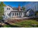 Home's backyard featuring a patio area, landscaped flower beds, lush lawn, and exterior home elevation at 107 Doris Ct, Lincolnton, NC 28092