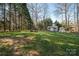 Spacious backyard featuring a shed, greenhouse, hammock and fire pit with wooded backdrop at 107 Doris Ct, Lincolnton, NC 28092