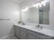 Bathroom featuring a double sink vanity, large mirror with modern lighting, and glass shower at 107 Doris Ct, Lincolnton, NC 28092