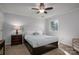 Comfortable bedroom features a ceiling fan, side tables, soft carpet, and a well-lit window at 107 Doris Ct, Lincolnton, NC 28092