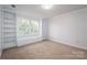 Sunlit bedroom with a window seat, built-in bookshelves and soft neutral carpet at 107 Doris Ct, Lincolnton, NC 28092