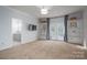 Bright bedroom features built-in bookshelves, plush carpet, ceiling fan, and french doors leading to the exterior at 107 Doris Ct, Lincolnton, NC 28092