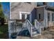 A charming deck with white railings and steps, complemented by flower-filled planters and outdoor seating at 107 Doris Ct, Lincolnton, NC 28092