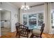 Cozy dining area with glass-top table features a bay window that provides views of the landscaped backyard at 107 Doris Ct, Lincolnton, NC 28092